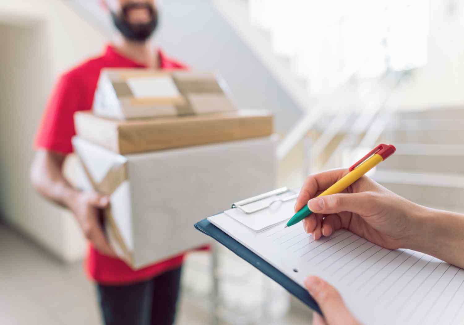 Holding parcel checking phone doorstep
